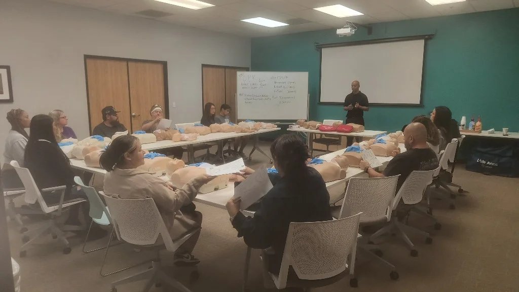 Instructor teaching a CPR class with clear explanations